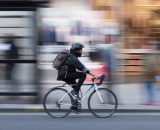 Cyclist riding through a busy London street