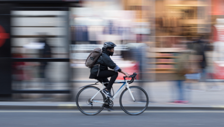 Cyclist riding through a busy London street