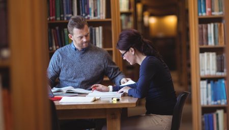 Adult skills: Two mature students study in a library