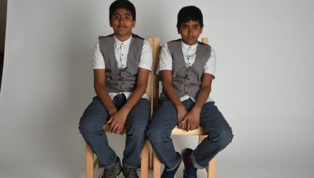 Two young boys. Dawood and Ishaaq, sitting on chairs.