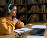 Researcher wears headphones to join a webinar