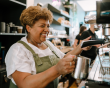 A middle-aged woman working in a coffee shop