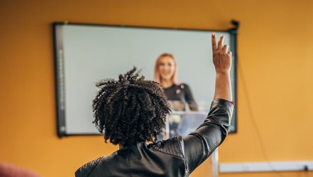 Woman raises her hand to suggest an idea