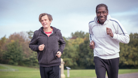 Two middle age men go for a jog