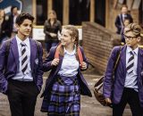 Teenages in school uniform walking out of school