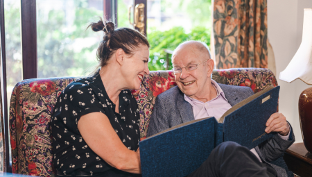 Elderly man smiling next to his adult daughter