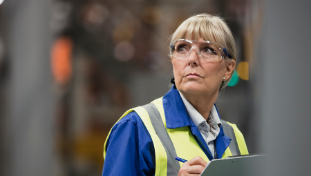 Middle aged woman at work wearing a hi-vis jacket