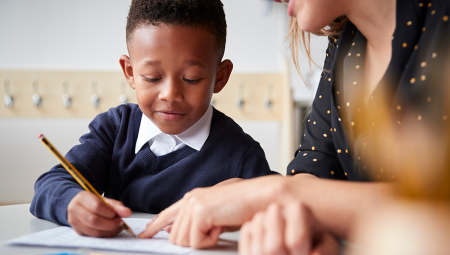 Young boy learning how to write