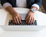 A person typing on a laptop