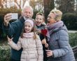 Grandparents pose for a selfie with their two young grandchildren