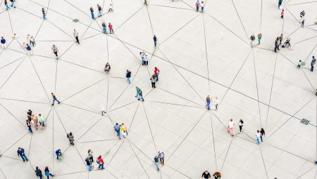 Bird's eye view of lots of people standing apart but connected by lines