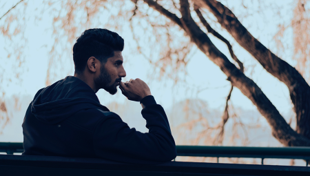 A young man sits alone