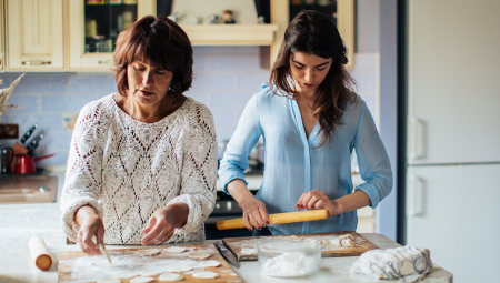 Mother and her teenage daughter baking together