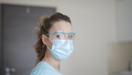 Woman wearing face shield and medical mask
