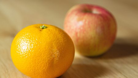 An orange and an apple side-by-side