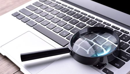 Magnifying glass placed on a laptop keyboard